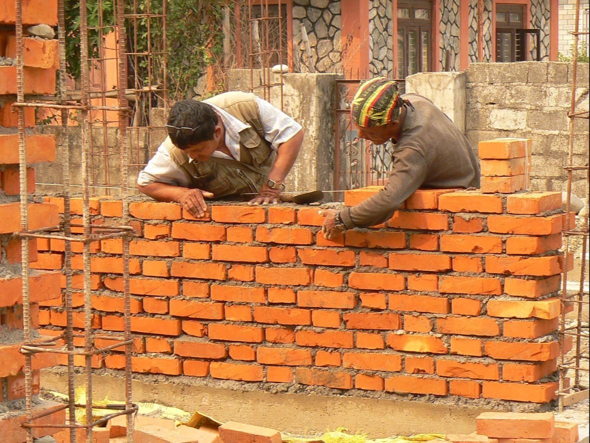 Mason laying bricks and tiles